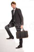 businessman climbing stairs with a briefcase