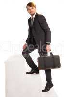 businessman climbing stairs with a briefcase