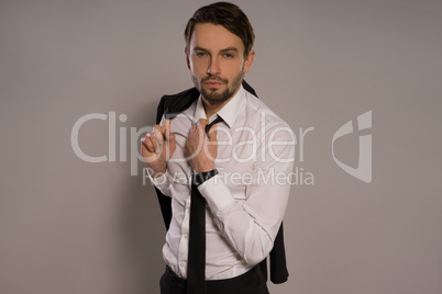 handsome businessman loosening his tie