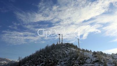 time lapse telecommunication tower and pine forest in winter