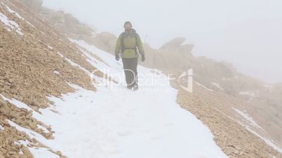 climber walking on snowy mountain