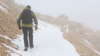 climber walking on snowy mountain