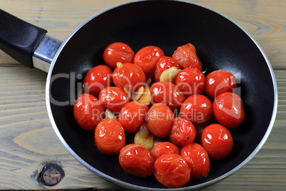 fried with seasonings mini tomatoes in pan.