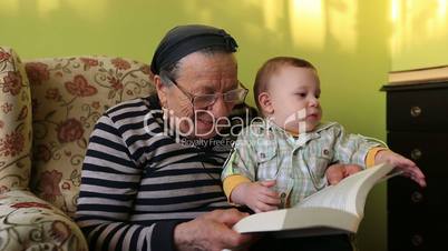 grandmother reading a book to grandson