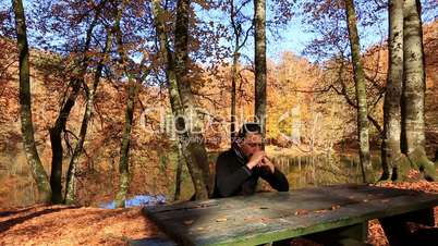 lonely sad man at park in autumn