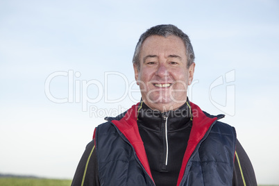 portrait of a gray-haired man while walking