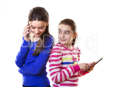 happy teen girls with digital tablet and smartphone