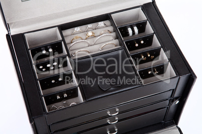 Black leather jewelery box with jewelry inside