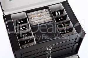 Black leather jewelery box with jewelry inside