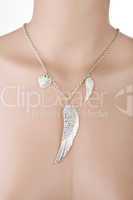 Silver necklace with angel wing and heart on a mannequin