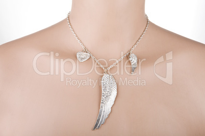 Silver necklace with angel wing and heart on a mannequin