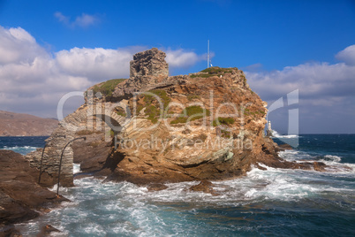 Rock and lighthouse on island Andros
