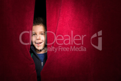 child appearing beneath the curtain