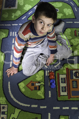 child is playing with cars