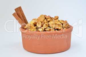 cinnamon and walnuts in clay  pot