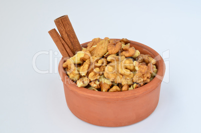 cinnamon and walnuts in clay  bowl
