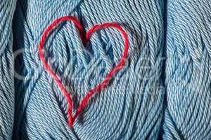 knitted red heart on blue