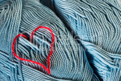knitted red heart on blue