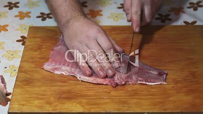 fisherman hands with knife making fillet