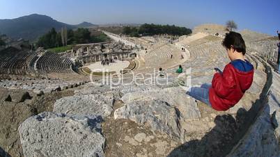 kid use boy smartphone in amphitheather