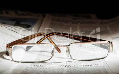 glasses on newspaper