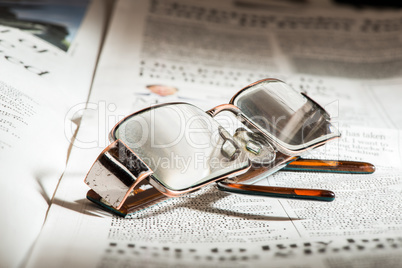 glasses on newspaper