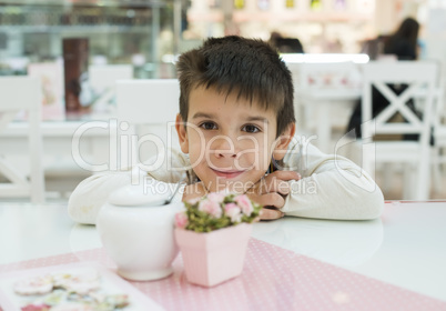 child on table in confectionery