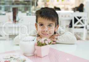 child on table in confectionery