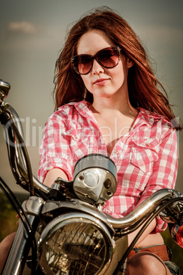 biker girl sitting on motorcycle