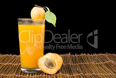 glass apricot juice and fruits black isolated.