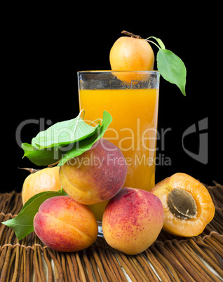 glass apricot juice and fruits black isolated.