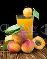 glass apricot juice and fruits black isolated.