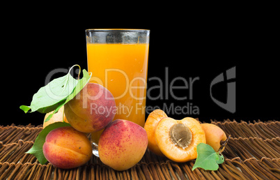 glass apricot juice and fruits black isolated.