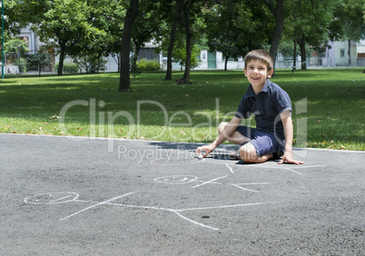 child drawing family on asphalt