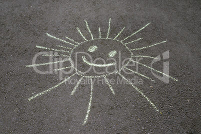 sun drawing on asphalt