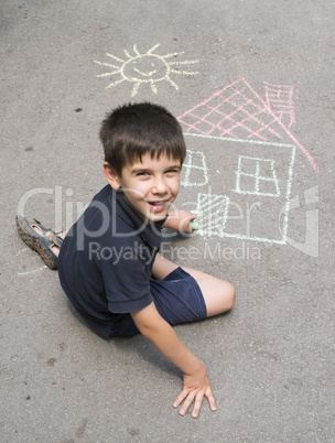 child drawing sun and house on asphal