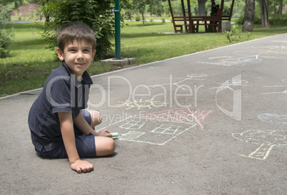 child drawing sun and house on asphal