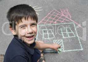 child drawing sun and house on asphal