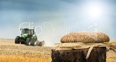 bread and wheat cereal crops.traktor on the background