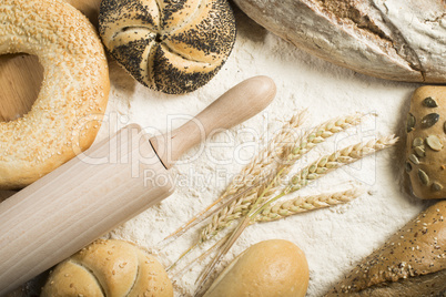 breads. pile of flour, rolling pin and wheat