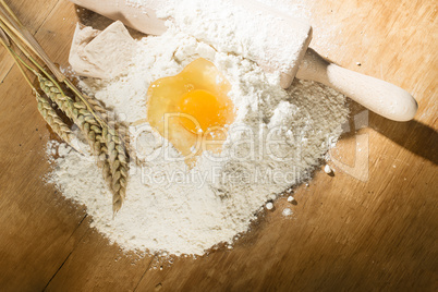 pile of flour, rolling pin and wheat