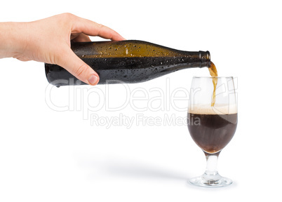 hand holding bottle of beer and beer mug