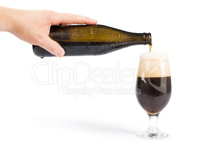 hand holding bottle of beer and beer mug