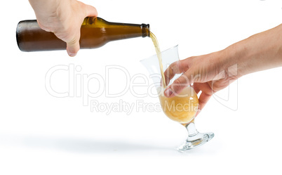 hand holding bottle of beer and beer mug