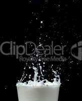 splashing milk on black background