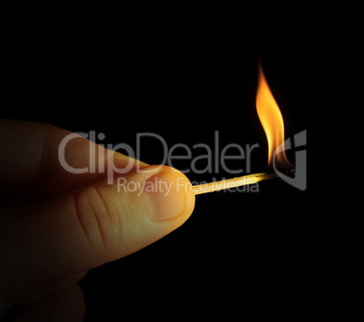 hand holding burning match stick
