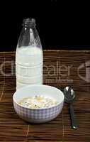 muesli breakfast in package.bottle milk and spoon