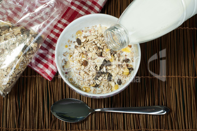 muesli breakfast in package.bottle milk and spoon