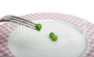 plate with peas and centimeter measure