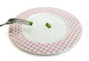 plate with peas and centimeter measure